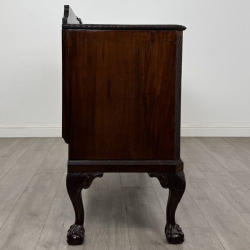 fig 8. An Edwardian mahogany sideboard featuring three central drawers flanked by two cupboard doors, resting on cabriole legs with claw and ball feet.