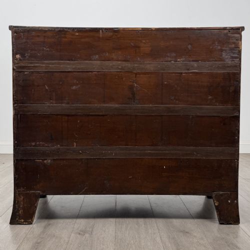 fig 4. An eighteenth-century Georgian bow-fronted mahogany chest of drawers with stringing inlay, oval brass handles, and splayed bracket feet.