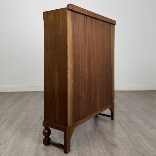 fig 4. A warm brown antique oak display cabinet featuring two glazed doors with wooden glazing bars and squat turned legs.