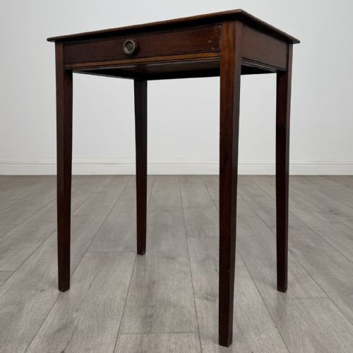 fig 1. An 18th-century Georgian mahogany side table with a single shallow drawer featuring a central circular brass pull, supported by four slim tapered legs.