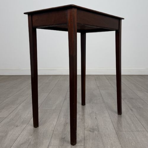 fig 3. An 18th-century Georgian mahogany side table with a single shallow drawer featuring a central circular brass pull, supported by four slim tapered legs.