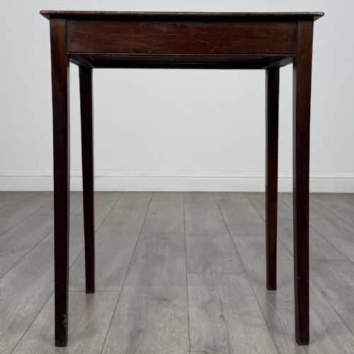 fig 4. An 18th-century Georgian mahogany side table with a single shallow drawer featuring a central circular brass pull, supported by four slim tapered legs.