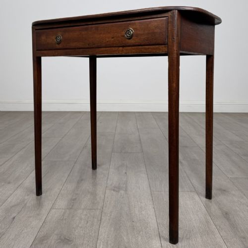 fig 1. A Georgian style mahogany side table featuring a single drawer with two circular brass handles and straight legs.