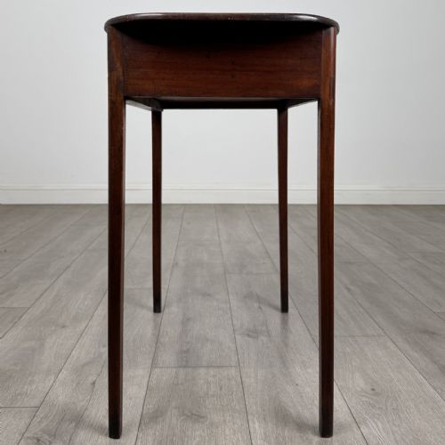 fig 2. A Georgian style mahogany side table featuring a single drawer with two circular brass handles and straight legs.
