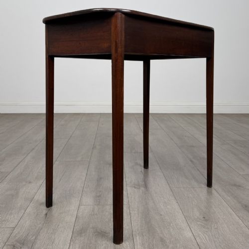 fig 3. A Georgian style mahogany side table featuring a single drawer with two circular brass handles and straight legs.