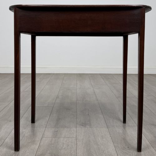 fig 4. A Georgian style mahogany side table featuring a single drawer with two circular brass handles and straight legs.