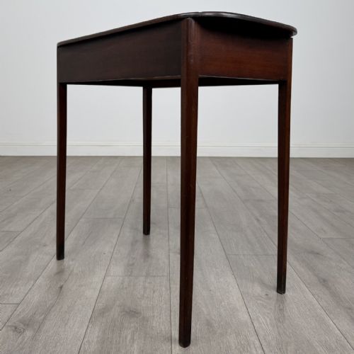fig 5. A Georgian style mahogany side table featuring a single drawer with two circular brass handles and straight legs.