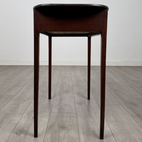fig 6. A Georgian style mahogany side table featuring a single drawer with two circular brass handles and straight legs.