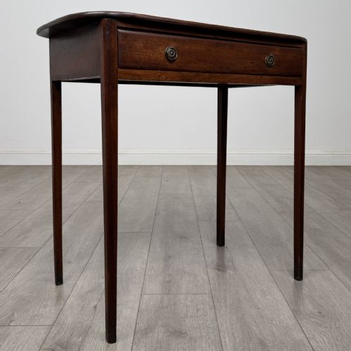 fig 7. A Georgian style mahogany side table featuring a single drawer with two circular brass handles and straight legs.