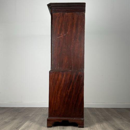 fig 1. An 18th-century Georgian mahogany chest on chest featuring two short over six long drawers with oval brass handles and bracket feet.