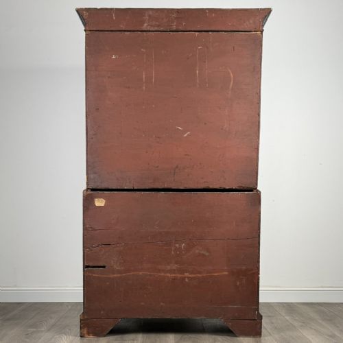 fig 2. An 18th-century Georgian mahogany chest on chest featuring two short over six long drawers with oval brass handles and bracket feet.