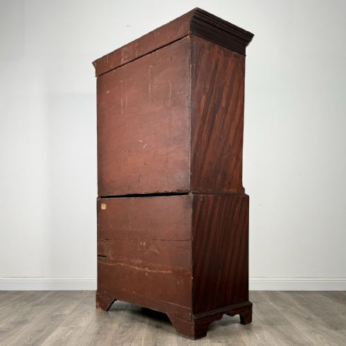 fig 3. An 18th-century Georgian mahogany chest on chest featuring two short over six long drawers with oval brass handles and bracket feet.