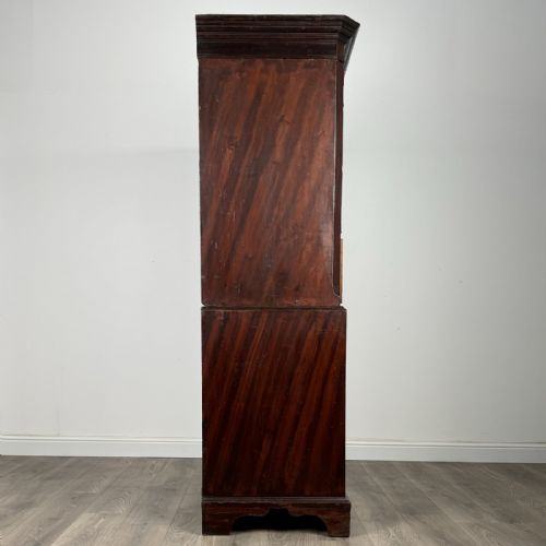 fig 4. An 18th-century Georgian mahogany chest on chest featuring two short over six long drawers with oval brass handles and bracket feet.