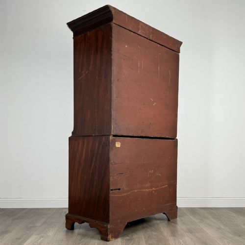 fig 7. An 18th-century Georgian mahogany chest on chest featuring two short over six long drawers with oval brass handles and bracket feet.