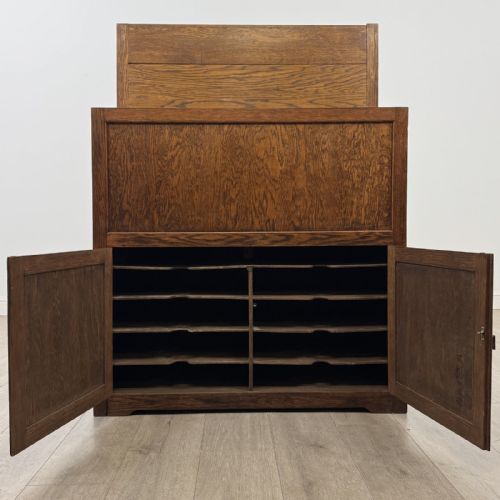 fig 1. An antique dark oak fitted cupboard featuring a smooth top section above two panelled lower cupboard doors.