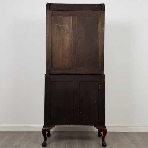 fig 5. An Edwardian walnut bureau bookcase with a glazed upper cabinet, slant-front writing desk, three drawers, and cabriole legs on claw and ball feet.