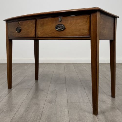 fig 1. An antique Georgian style mahogany side table featuring two front drawers with oval brass handles and four tapered square legs.