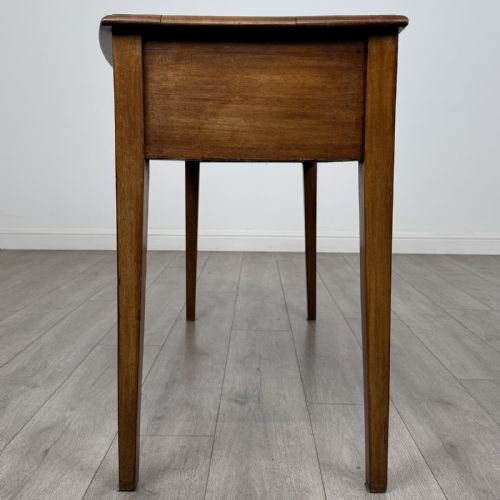 fig 2. An antique Georgian style mahogany side table featuring two front drawers with oval brass handles and four tapered square legs.