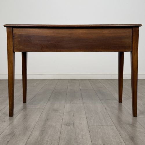 fig 4. An antique Georgian style mahogany side table featuring two front drawers with oval brass handles and four tapered square legs.