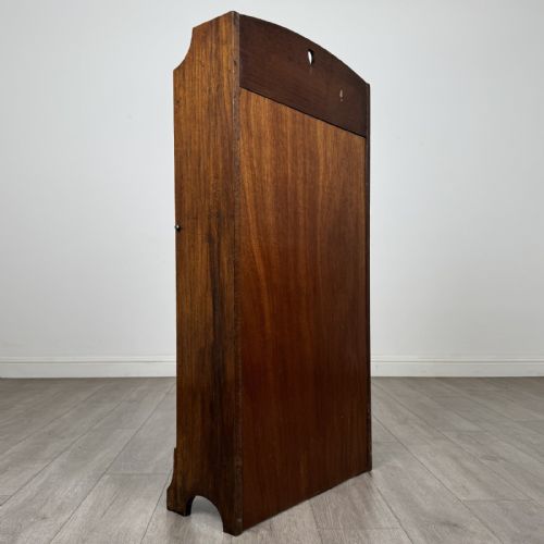 fig 4. An Arts and Crafts golden oak bureau with a heart cutout on the top gallery back, a fall-front writing surface with drop handles, and two open bookshelves underneath.