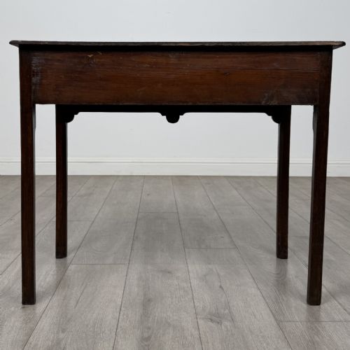fig 4. An 18th-century Georgian dark oak side table featuring a single drawer with pierced brass handles and straight square legs.