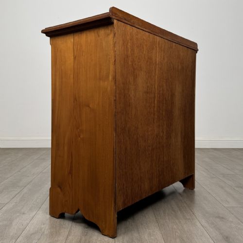 fig 3. An antique ash chest of drawers featuring a two-over-three drawer configuration with drop handles and a shaped lower apron.