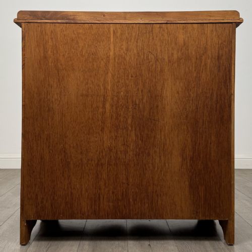 fig 4. An antique ash chest of drawers featuring a two-over-three drawer configuration with drop handles and a shaped lower apron.