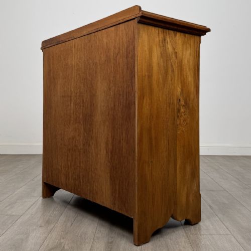 fig 5. An antique ash chest of drawers featuring a two-over-three drawer configuration with drop handles and a shaped lower apron.