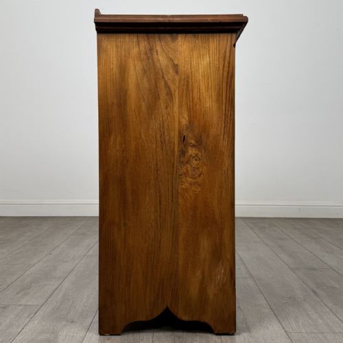 fig 6. An antique ash chest of drawers featuring a two-over-three drawer configuration with drop handles and a shaped lower apron.