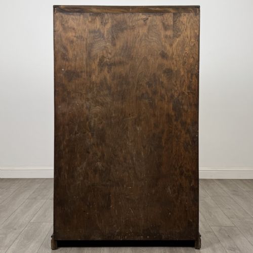 fig 5. A tall dark brown oak double wardrobe featuring hand-carved Gothic tracery panels on top and vertical panel detail below.