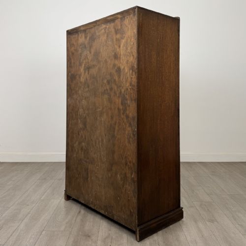fig 6. A tall dark brown oak double wardrobe featuring hand-carved Gothic tracery panels on top and vertical panel detail below.