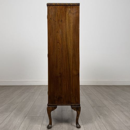 fig 3. An antique Edwardian mahogany display cabinet featuring twin glazed doors, glass interior shelving, and cabriole legs.