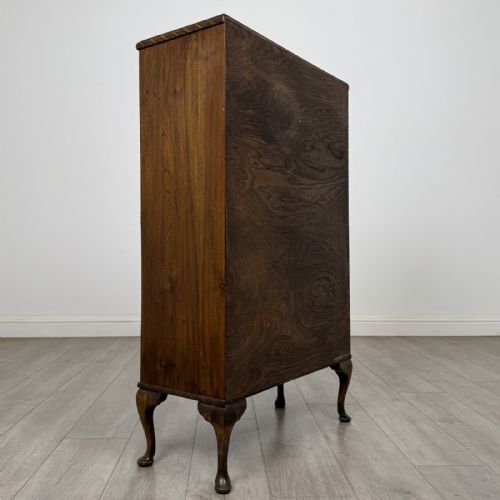 fig 4. An antique Edwardian mahogany display cabinet featuring twin glazed doors, glass interior shelving, and cabriole legs.