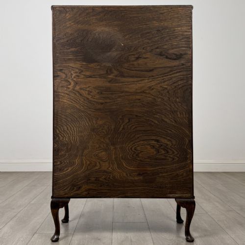 fig 5. An antique Edwardian mahogany display cabinet featuring twin glazed doors, glass interior shelving, and cabriole legs.