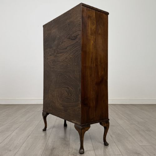 fig 6. An antique Edwardian mahogany display cabinet featuring twin glazed doors, glass interior shelving, and cabriole legs.