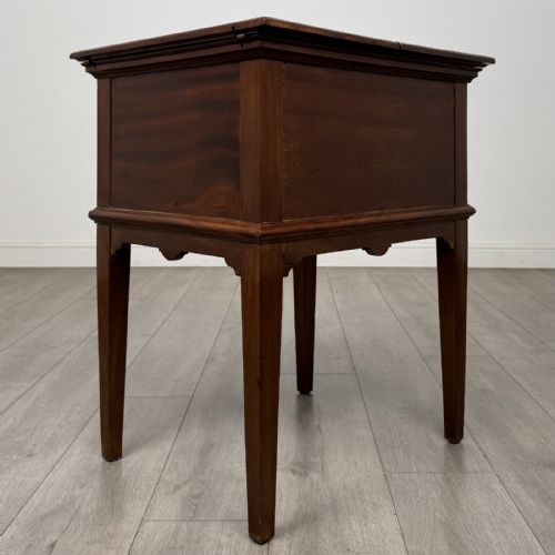 fig 5. A 19th-century mahogany fold-out cabinet standing on four square tapered legs with a brass keyhole escutcheon on the front casing.