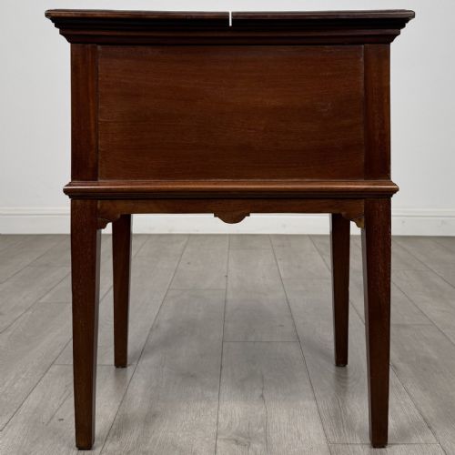 fig 6. A 19th-century mahogany fold-out cabinet standing on four square tapered legs with a brass keyhole escutcheon on the front casing.