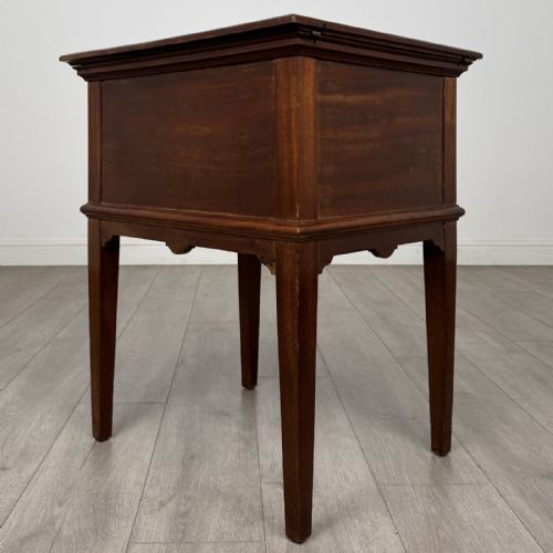 fig 7. A 19th-century mahogany fold-out cabinet standing on four square tapered legs with a brass keyhole escutcheon on the front casing.