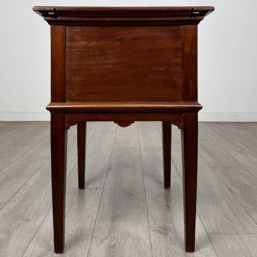 fig 8. A 19th-century mahogany fold-out cabinet standing on four square tapered legs with a brass keyhole escutcheon on the front casing.
