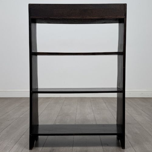 fig 5. A dark brown Edwardian oak open bookcase featuring four open shelf tiers and shaped side panels.