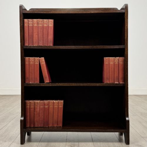 fig 1. A dark brown Edwardian oak open bookcase featuring two internal fixed shelves and simple vertical side panels.