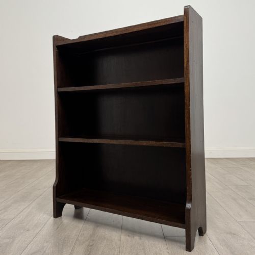 fig 2. A dark brown Edwardian oak open bookcase featuring two internal fixed shelves and simple vertical side panels.
