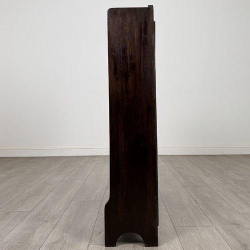 fig 3. A dark brown Edwardian oak open bookcase featuring two internal fixed shelves and simple vertical side panels.