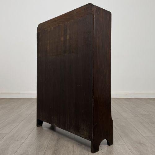 fig 6. A dark brown Edwardian oak open bookcase featuring two internal fixed shelves and simple vertical side panels.