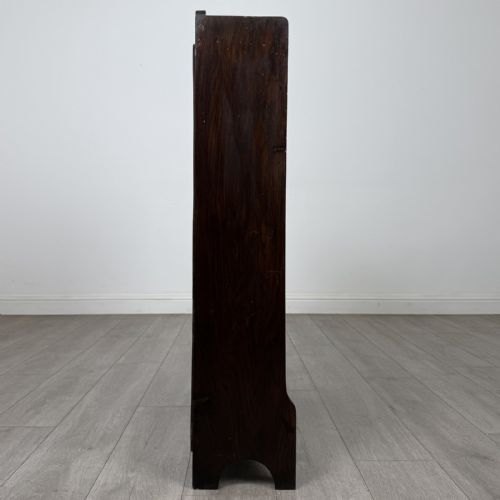 fig 7. A dark brown Edwardian oak open bookcase featuring two internal fixed shelves and simple vertical side panels.