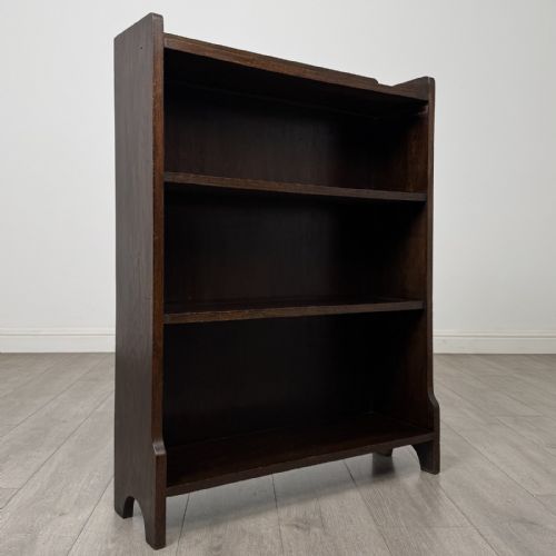 fig 8. A dark brown Edwardian oak open bookcase featuring two internal fixed shelves and simple vertical side panels.