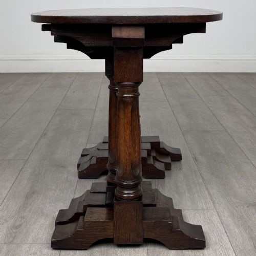 fig 5. A set of three nesting dark oak occasional tables featuring turned baluster legs and trestle feet.