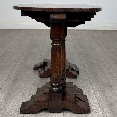 fig 7. A set of three nesting dark oak occasional tables featuring turned baluster legs and trestle feet.