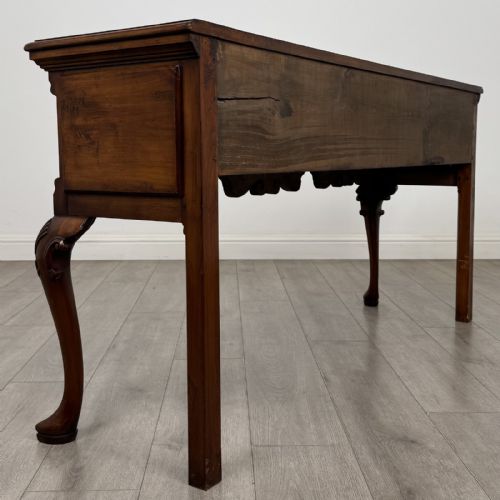 fig 3. A Queen Anne style elm dresser base featuring three drawers with brass handles, a shaped apron, and cabriole legs ending in pad feet.