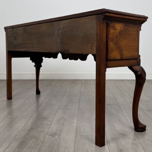 fig 5. A Queen Anne style elm dresser base featuring three drawers with brass handles, a shaped apron, and cabriole legs ending in pad feet.